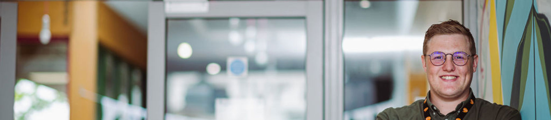 Photo of a office worker standing outside door