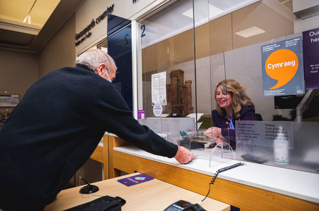 Man speaking with Natwest staff member