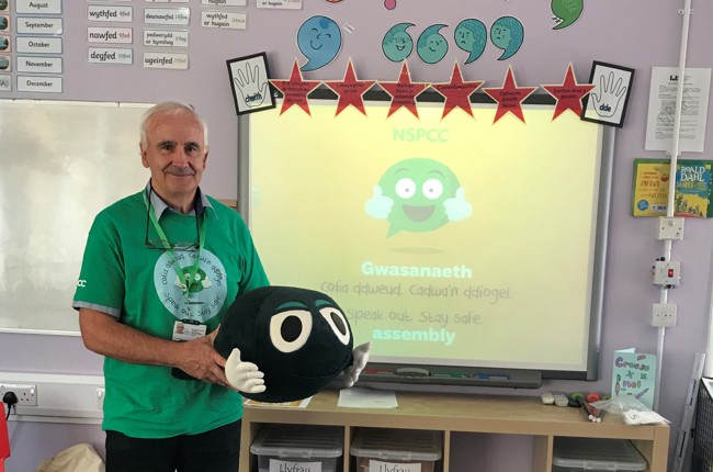 NSPCC volunteer standing in a classroom