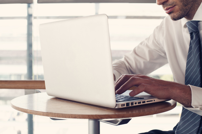 Photo of man behind laptop