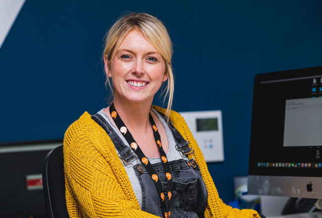 Woman working in an office smiling