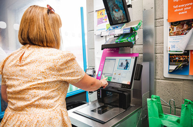 Woman using self service machine