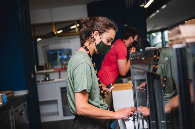 A woman making coffee in a cafe