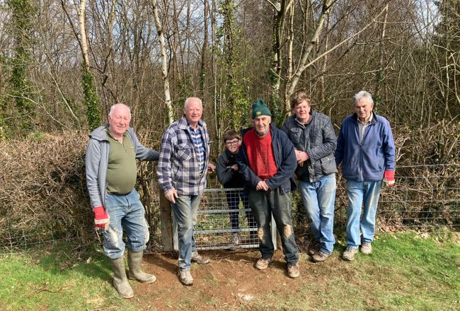 Volunteers from Ramblers Cymru standing in a field