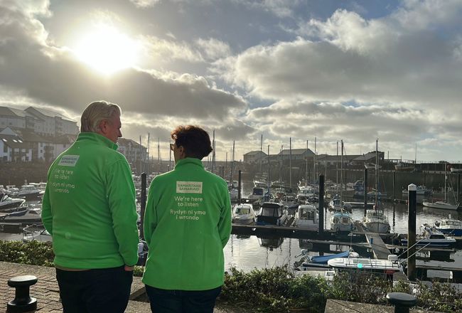 Samaritans volunteers standing by boats