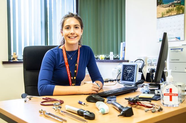 Doctor sitting by desk